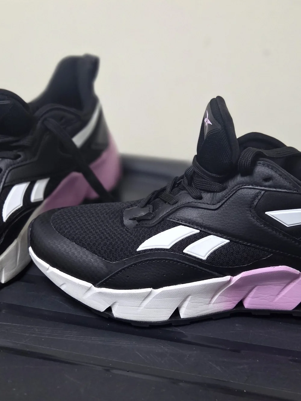 Reebok Black Athletic Sneakers with White Stripes and Pink Logo